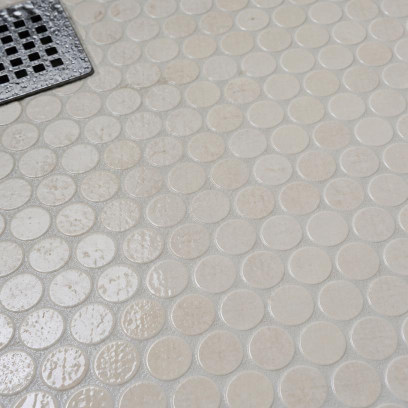 Cream penny-round mosaic shower floor detail